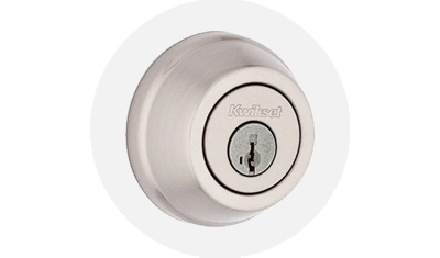 Kwikset 780 Collection Residential Deadbolt product isolated on top of a gray circle
